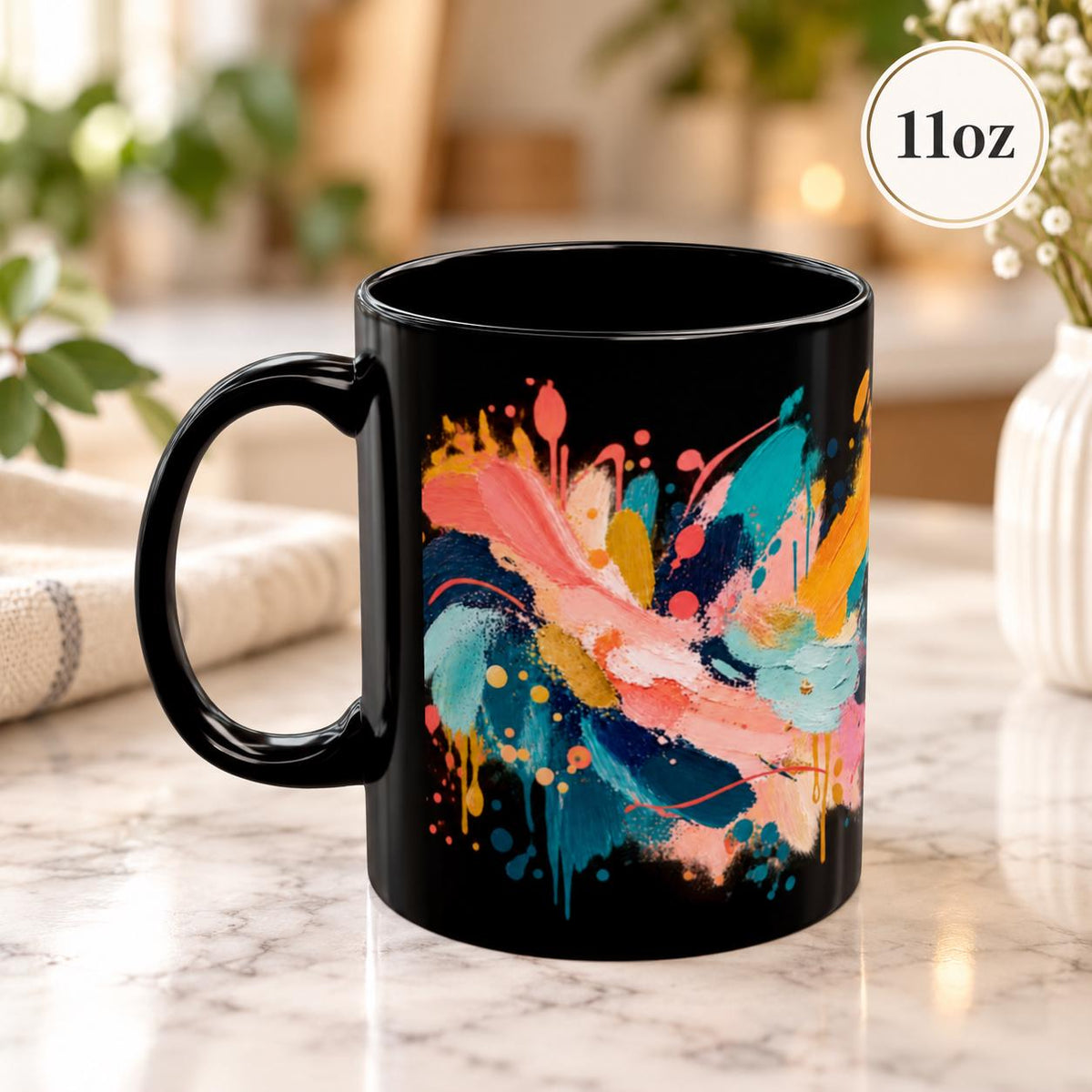 11 oz coffee cup angled to display vibrant painterly strokes, splashes, and layered modern art details against the dark background.