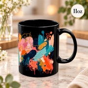 11 oz black ceramic mug shown from the opposite side, highlighting the expressive abstract design in warm and cool tones.
