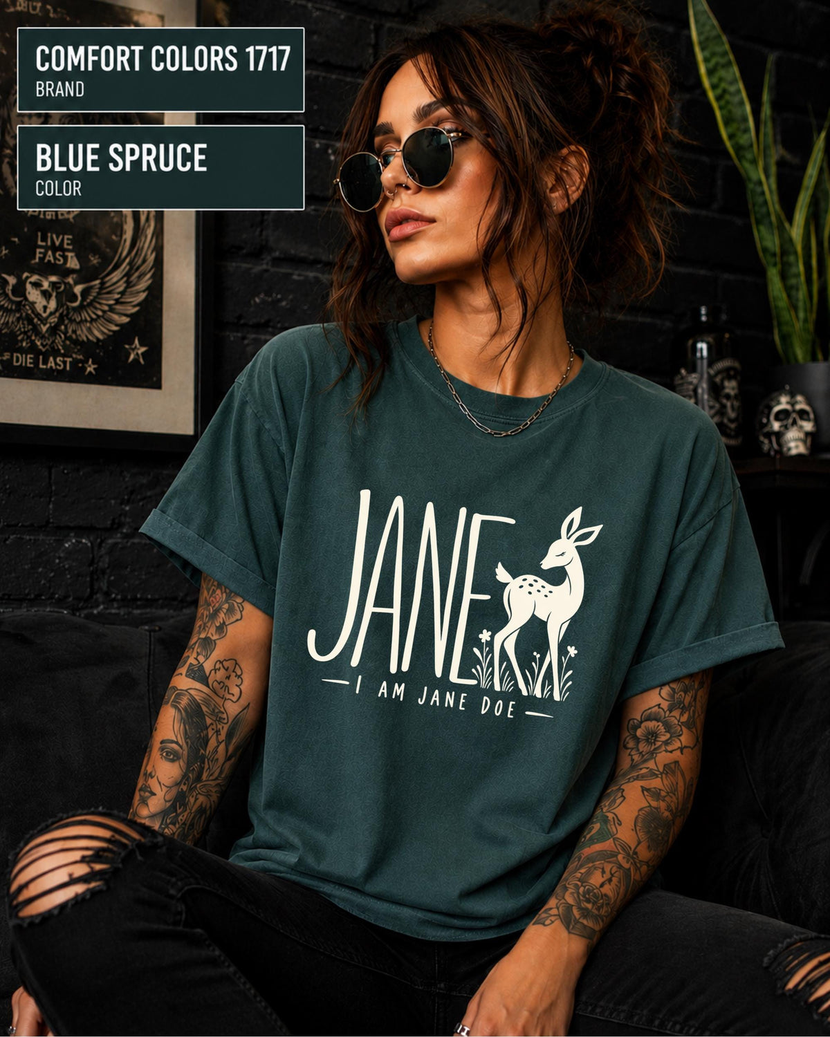 Blue Spruce unisex tee showcasing the Jane design with cream typography, doe illustration, and subtle botanical accents.