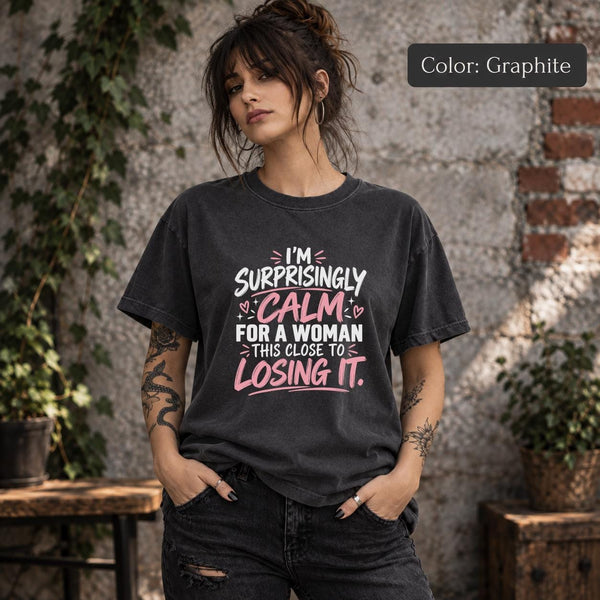 Graphite Comfort Colors 1717 T-shirt featuring the phrase “I’m Surprisingly Calm for a Woman This Close to Losing It” in pink and white lettering.