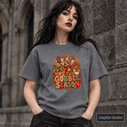 Graphite Heather shirt displaying the autumn turkey design with bold lettering and cozy harvest colors.