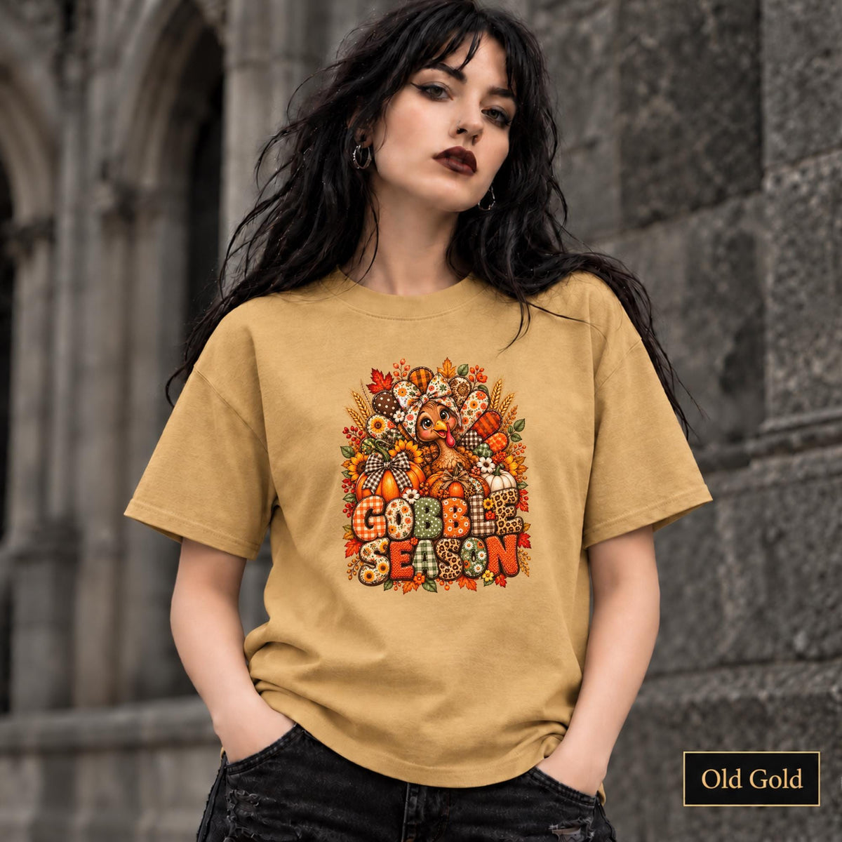 Old Gold tee featuring the autumn holiday artwork with warm harvest tones and layered seasonal details.