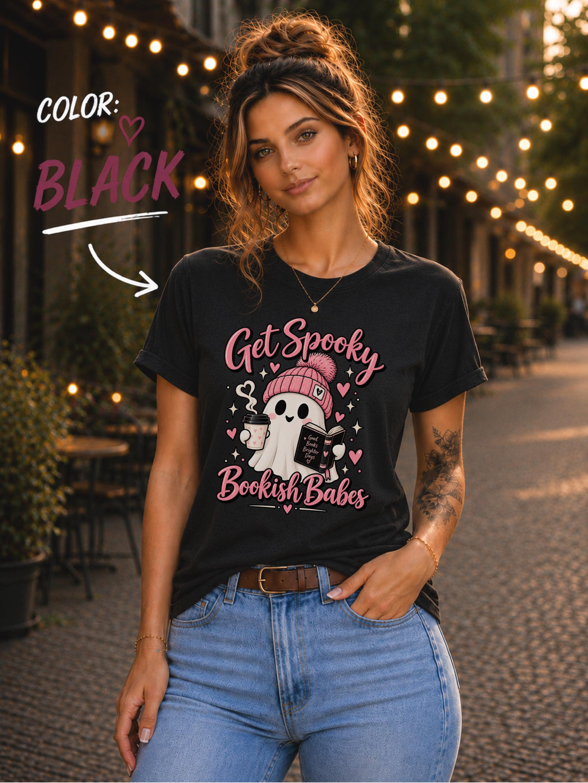 Get Spooky Bookish Babes T-shirt featuring a cute ghost in a pink beanie holding a book and coffee, with hearts and stars on a black shirt.