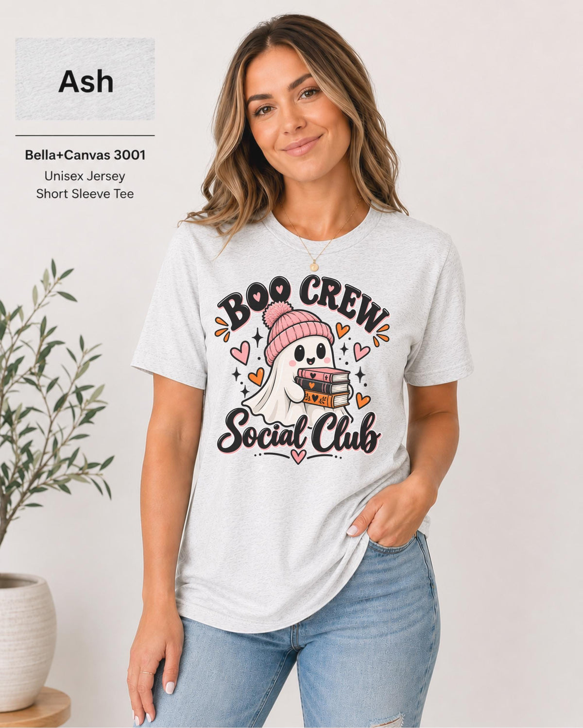 Boo Crew Social Club T-shirt in Ash featuring a cute ghost in a pink beanie holding books, with hearts, sparkles, and playful Halloween lettering.