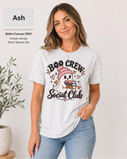 Boo Crew Social Club T-shirt in Ash featuring a cute ghost in a pink beanie holding books, with hearts, sparkles, and playful Halloween lettering.