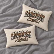 Two matching cream Sawdust Soul lumbar pillows arranged on soft gray bedding, showing the rustic woodland typography design from different angles.