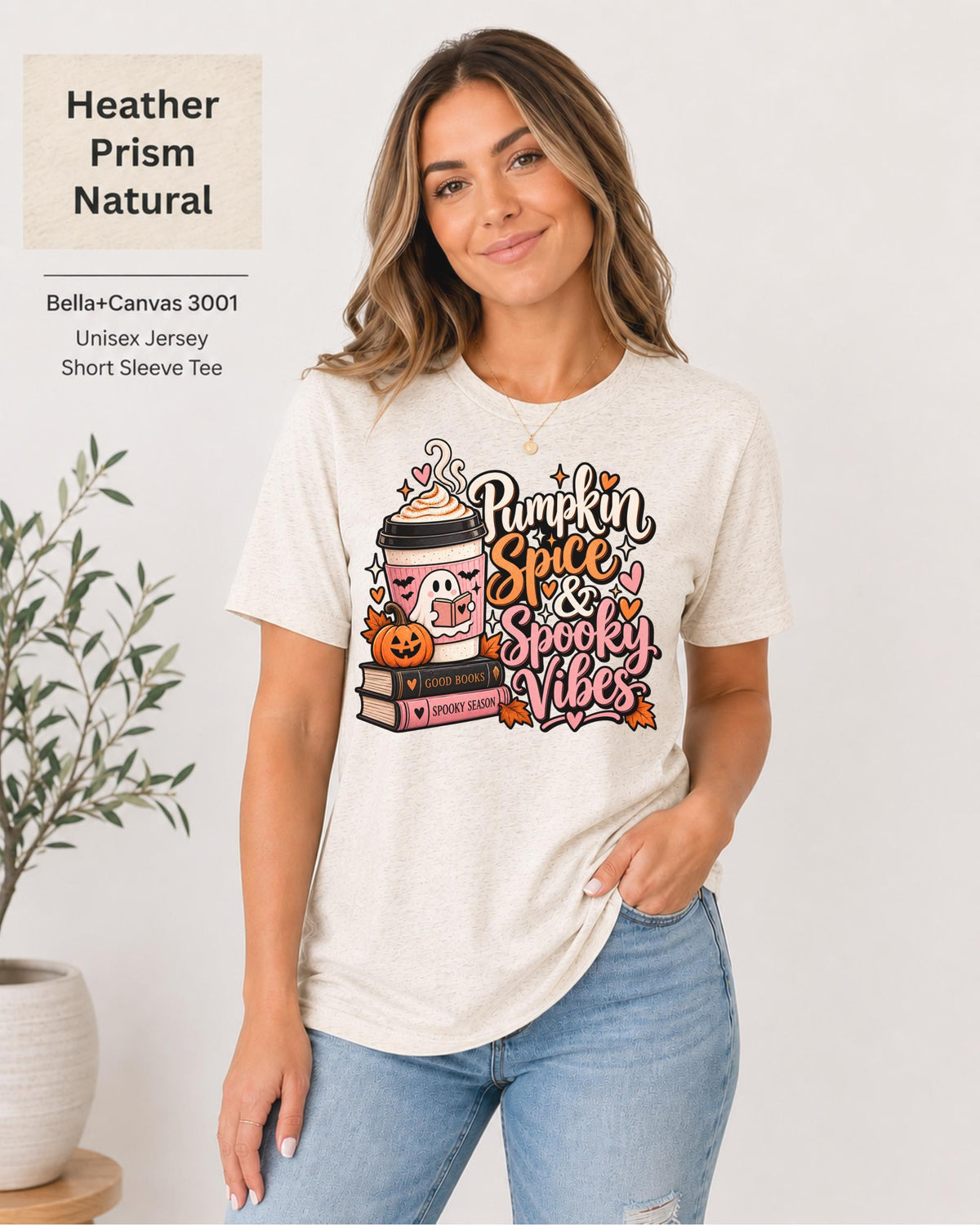 Bella+Canvas 3001 Heather Prism Natural unisex T-shirt featuring a “Pumpkin Spice & Spooky Vibes” design with a ghost reading, fall coffee, stacked books, jack-o’-lantern, hearts, and autumn leaves.