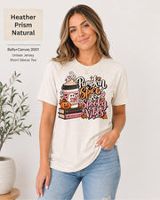 Bella+Canvas 3001 Heather Prism Natural unisex T-shirt featuring a “Pumpkin Spice & Spooky Vibes” design with a ghost reading, fall coffee, stacked books, jack-o’-lantern, hearts, and autumn leaves.