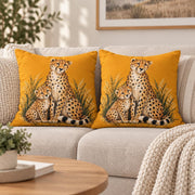 Two matching cheetah pillows styled together on a neutral sofa in a warm modern living room setting.