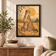 Framed golden cheetah artwork displayed above a wood cabinet in a cozy sunlit interior with botanical accents.