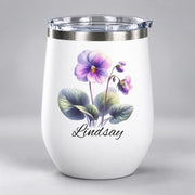 White personalized tumbler showcasing the violet flower illustration with “Lindsay” printed beneath the botanical artwork.