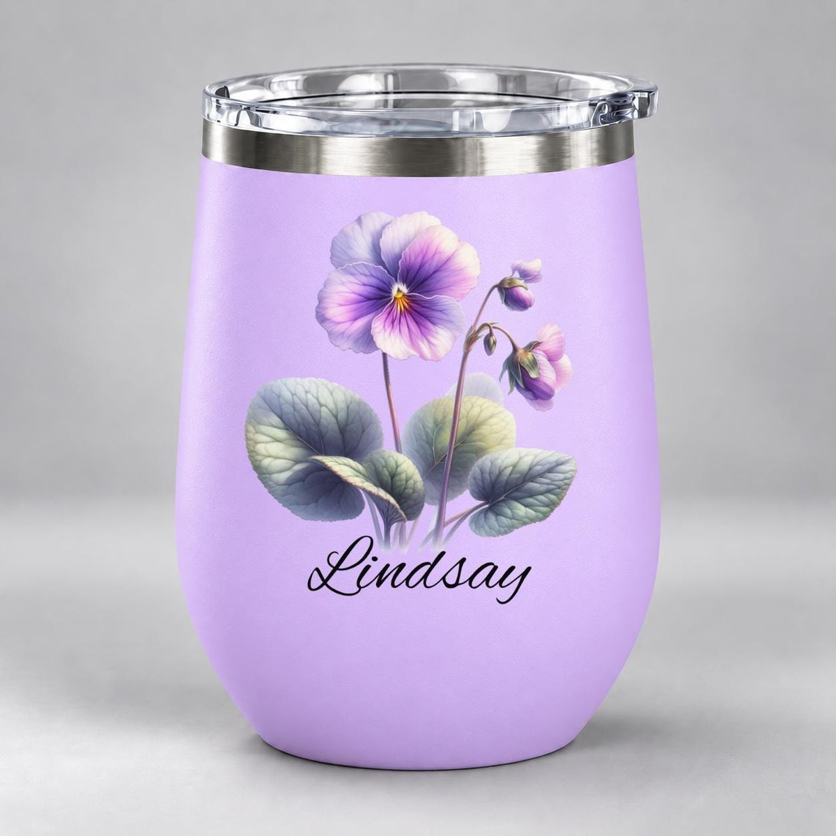 Light purple stemless wine tumbler featuring the watercolor violet birth flower and custom name in elegant black lettering.