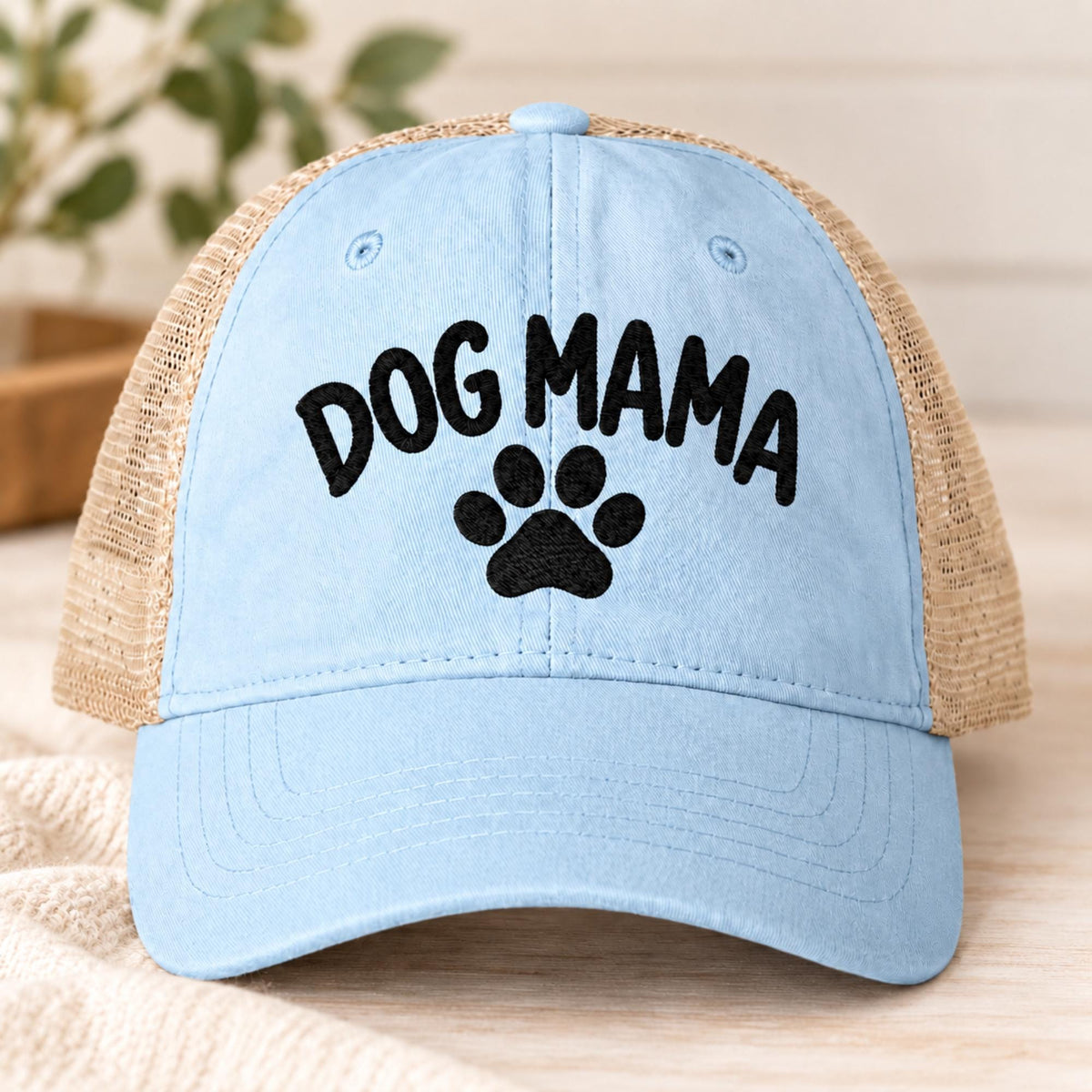 Cashmere blue cap displaying the embroidered Dog Mama message with paw print and tan mesh panels.