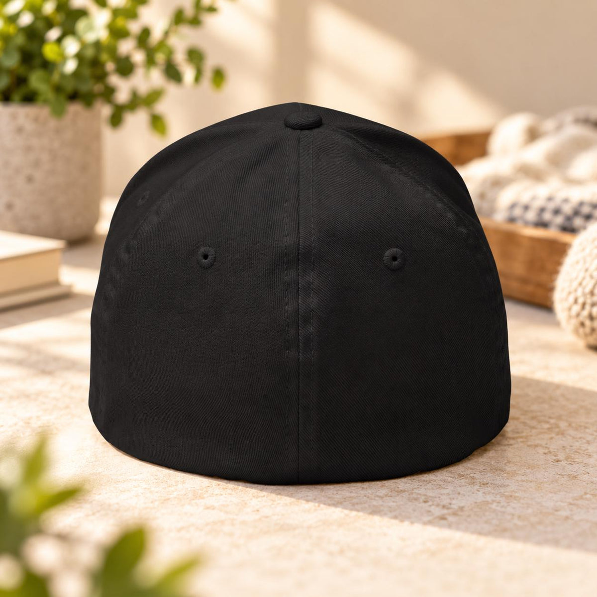 Back view of the black Flexfit cap showing the closed-back stretch-fit construction and structured crown.