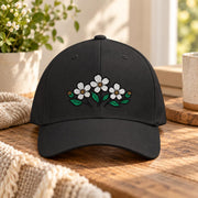 Black structured cap featuring the small flower bouquet embroidery for a simple botanical look.