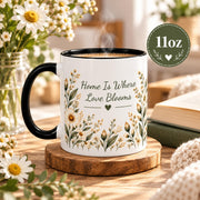 11oz black accent mug showcasing the floral phrase design with daisies, greenery, and warm botanical details.