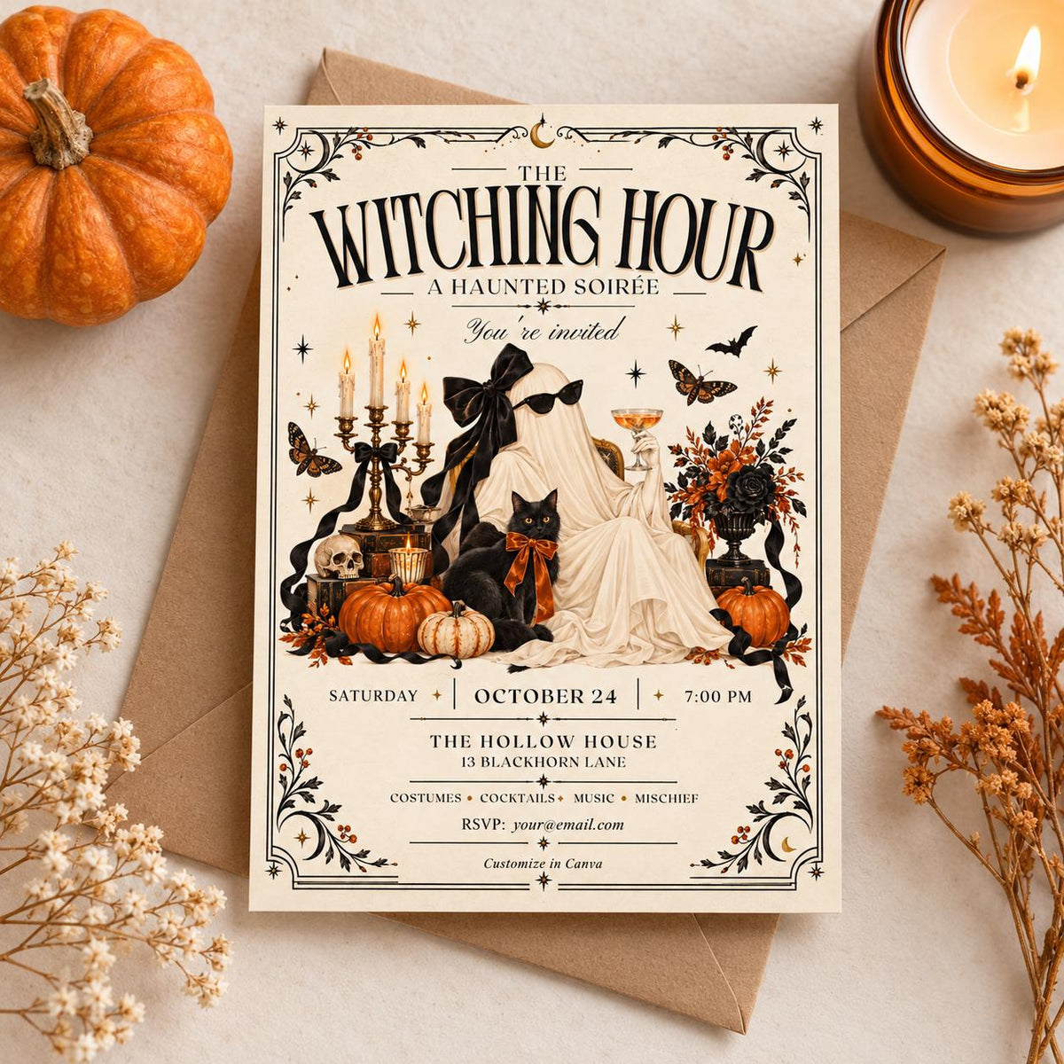 The Witching Hour Halloween invitation displayed on a clean autumn flatlay with envelope, pumpkin, candle, and dried florals.