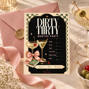 Dirty Thirty invitation paired with blush envelope, martini wax seal, pink ribbon, and cocktail accessories.