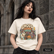 Natural unisex T-shirt featuring a colorful “Ghoul Friends Forever” Halloween graphic with a ghost, black cat, pumpkin, witchy skeleton, bats, mushrooms, crescent moon, and autumn accents.