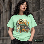 Mint Green unisex T-shirt featuring a colorful “Ghoul Friends Forever” Halloween graphic with a ghost, black cat, pumpkin, witchy skeleton, bats, mushrooms, crescent moon, and autumn accents.
