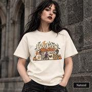 Natural unisex T-shirt featuring a “Boo Crew After Dark” Halloween design with ghosts, skeletons, pumpkins, books, bats, drinks, and a crescent moon in retro orange and cream tones.