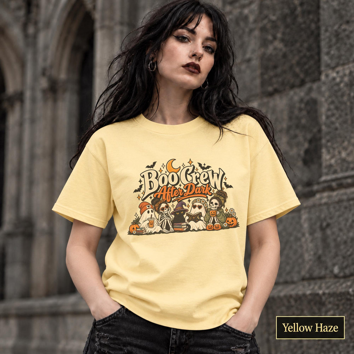 Yellow Haze unisex T-shirt featuring a “Boo Crew After Dark” Halloween design with ghosts, skeletons, pumpkins, books, bats, drinks, and a crescent moon in retro orange and cream tones.