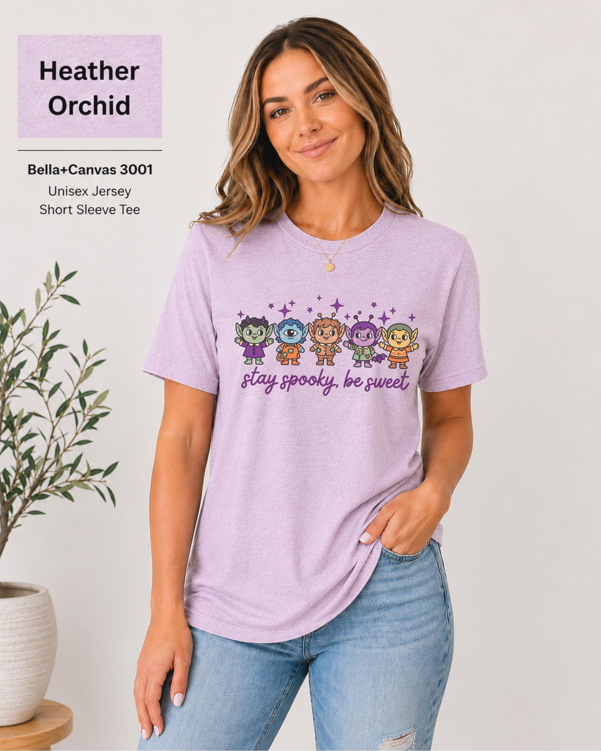 Bella+Canvas 3001 Heather Orchid unisex T-shirt featuring five cute Halloween-inspired characters with stars and the phrase “Stay Spooky, Be Sweet” in a small centered chest design.