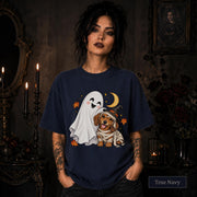 True Navy unisex T-shirt featuring a smiling white ghost beside a mummy-wrapped puppy wearing a witch hat, with a crescent moon, stars, and orange autumn leaves.