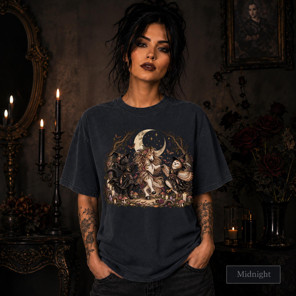 Midnight unisex T-shirt featuring a gothic fantasy scene with a unicorn, owls, raven, crescent moon, mushrooms, candles, flowers, and twisted woodland branches.