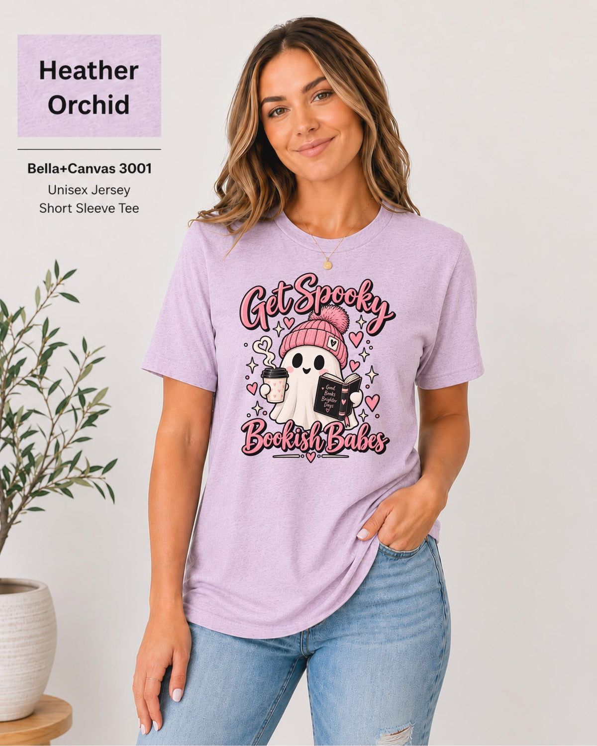 Bella+Canvas 3001 Heather Orchid unisex T-shirt featuring a cute ghost in a pink beanie holding coffee and a book with “Get Spooky Bookish Babes” lettering, hearts, and stars.