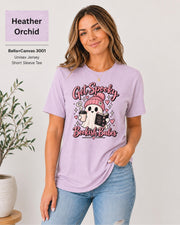 Bella+Canvas 3001 Heather Orchid unisex T-shirt featuring a cute ghost in a pink beanie holding coffee and a book with “Get Spooky Bookish Babes” lettering, hearts, and stars.