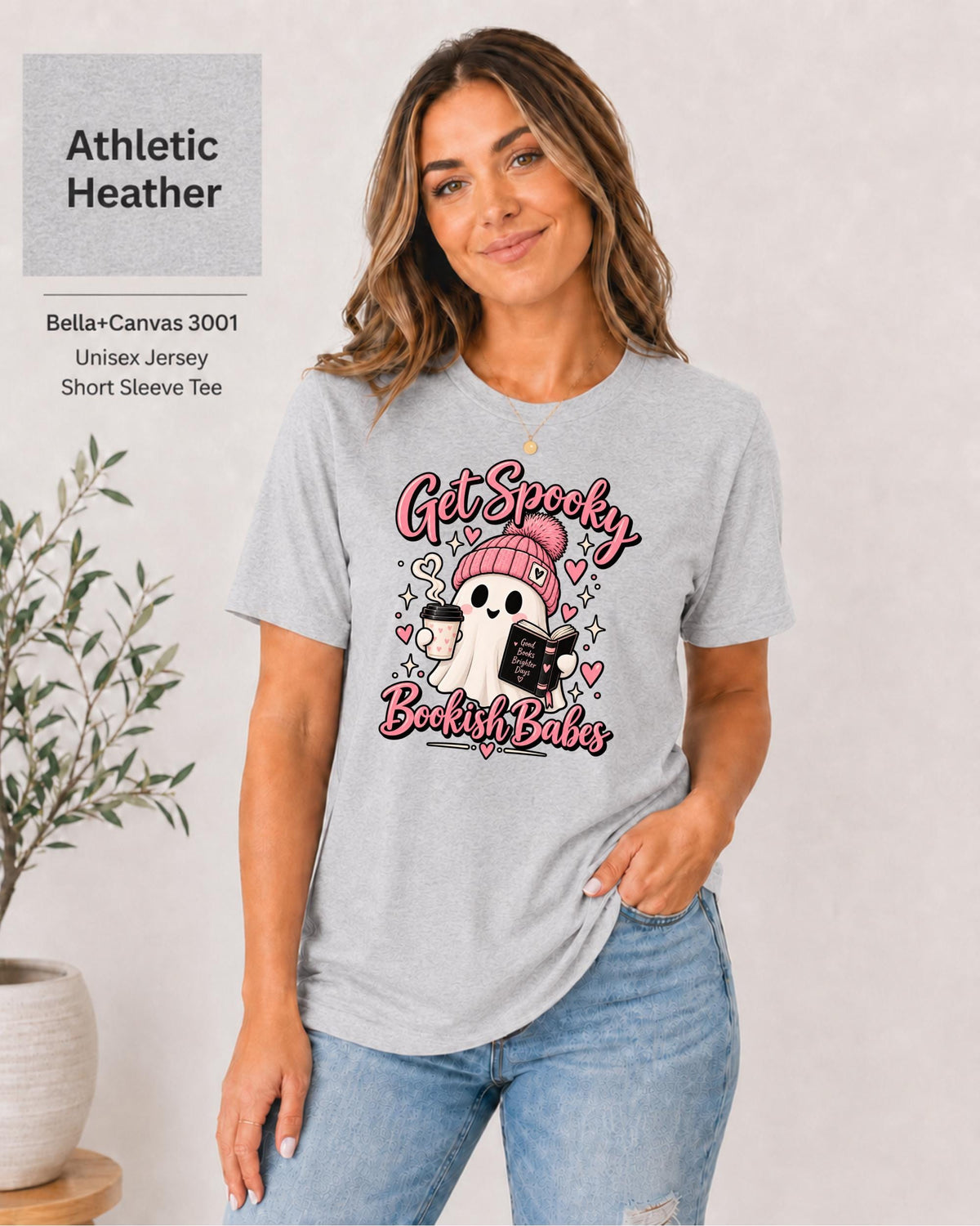 Bella+Canvas 3001 Athletic Heather unisex T-shirt featuring a cute ghost in a pink beanie holding coffee and a book with “Get Spooky Bookish Babes” lettering, hearts, and stars.