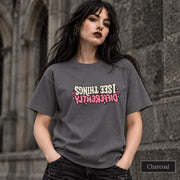 Charcoal shirt displaying the bold self-growth statement design with vintage-style cream typography and pink accent text.