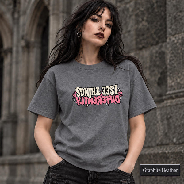 Graphite Heather T-shirt showcasing the confidence-inspired statement design with bold typography and feminine pink details.