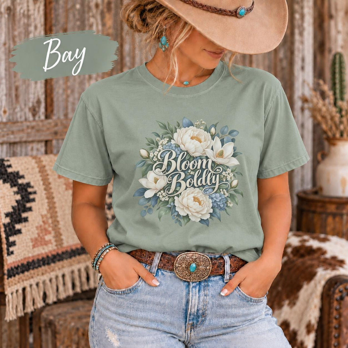 Bay Comfort Colors tee featuring the botanical artwork with cream flowers, blue accents, and a soft nature-inspired aesthetic.