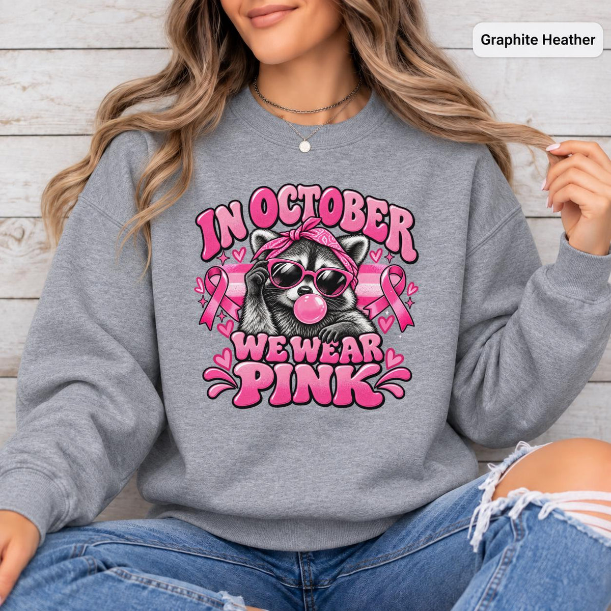 Sport Grey sweatshirt featuring the retro pink ribbon raccoon artwork for Breast Cancer Awareness Month and October events.