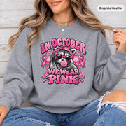 Sport Grey sweatshirt featuring the retro pink ribbon raccoon artwork for Breast Cancer Awareness Month and October events.