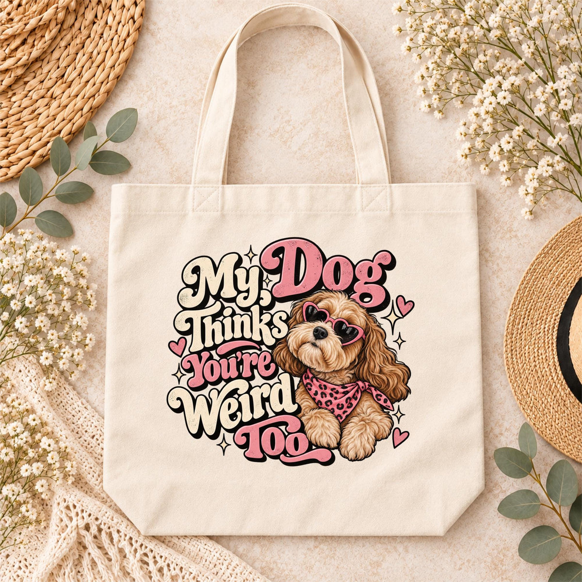 Cream canvas tote bag mockup showing the funny dog lover PNG artwork with playful pink and cream lettering, styled with neutral boho accessories.