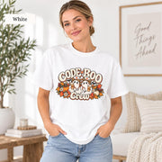 White Comfort Colors T-shirt featuring the “Code Boo Crew” Halloween nurse design with two ghost nurses, stethoscopes, pumpkins, and fall florals.