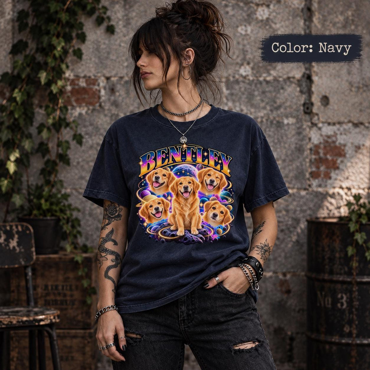 Woman modeling a dark Navy T-shirt with a personalized dog portrait design showing Bentley in several poses surrounded by planets and glowing stars.