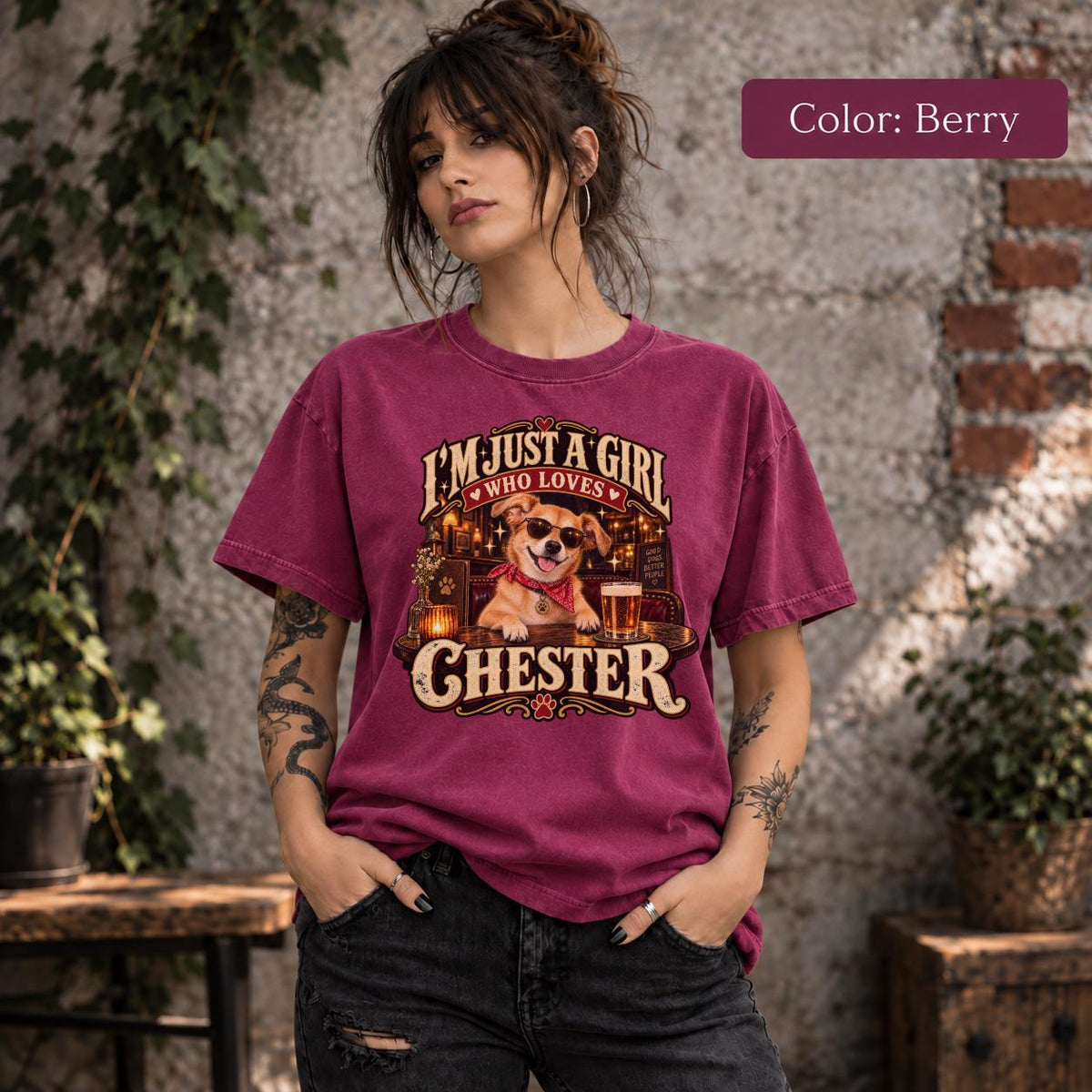 Woman modeling a berry-colored Comfort Colors T-shirt featuring Chester's personalized vintage pet portrait with cream lettering, retro pub scenery and a golden dog illustration.