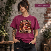 Woman modeling a berry-colored Comfort Colors T-shirt featuring Chester's personalized vintage pet portrait with cream lettering, retro pub scenery and a golden dog illustration.