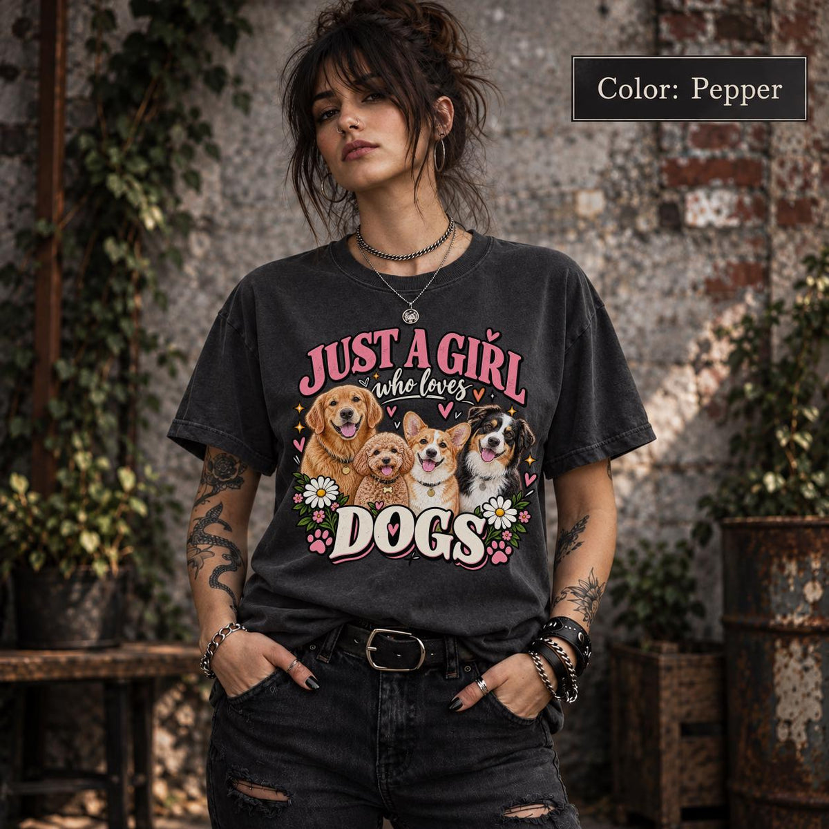 Model wearing a Pepper T-shirt with colorful dog lover artwork featuring four happy dogs, distressed pink lettering, white flowers and playful hearts.