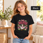 Young girl wearing a black Silly Goose Birthday Girl graphic tee featuring a white goose with a pink bow, colorful floral accents and whimsical birthday artwork.