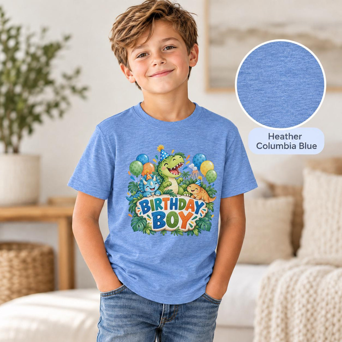 Young boy modeling a heather columbia blue dinosaur birthday shirt featuring a green dinosaur, blue triceratops, orange stegosaurus and festive Birthday Boy lettering.