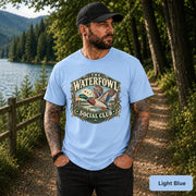 Light Blue T-shirt featuring the mallard artwork with marsh scenery and vintage outdoor club lettering.