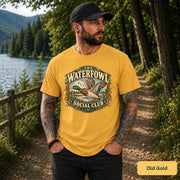 Old Gold shirt showcasing the flying duck design with lake, grass, and classic hunting-inspired graphic details.