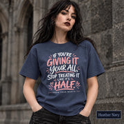 Navy tee featuring the empowering quote design in pink and white text with a clean statement layout.