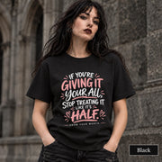 Black unisex T-shirt featuring the quote “If You’re Giving It Your All, Stop Treating It Like It’s Half. Know Your Worth” in pink and white lettering.