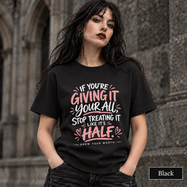 Black unisex T-shirt featuring the quote “If You’re Giving It Your All, Stop Treating It Like It’s Half. Know Your Worth” in pink and white lettering.
